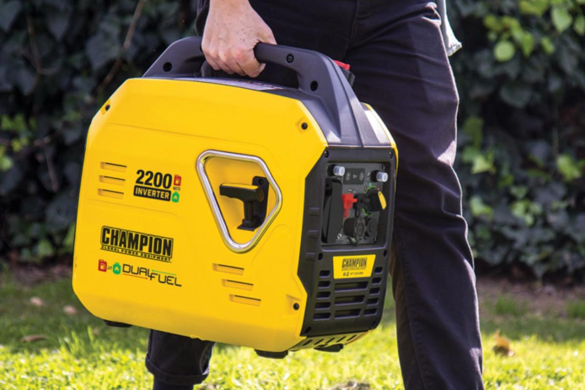 Man holding yellow Champion dual fuel generator.